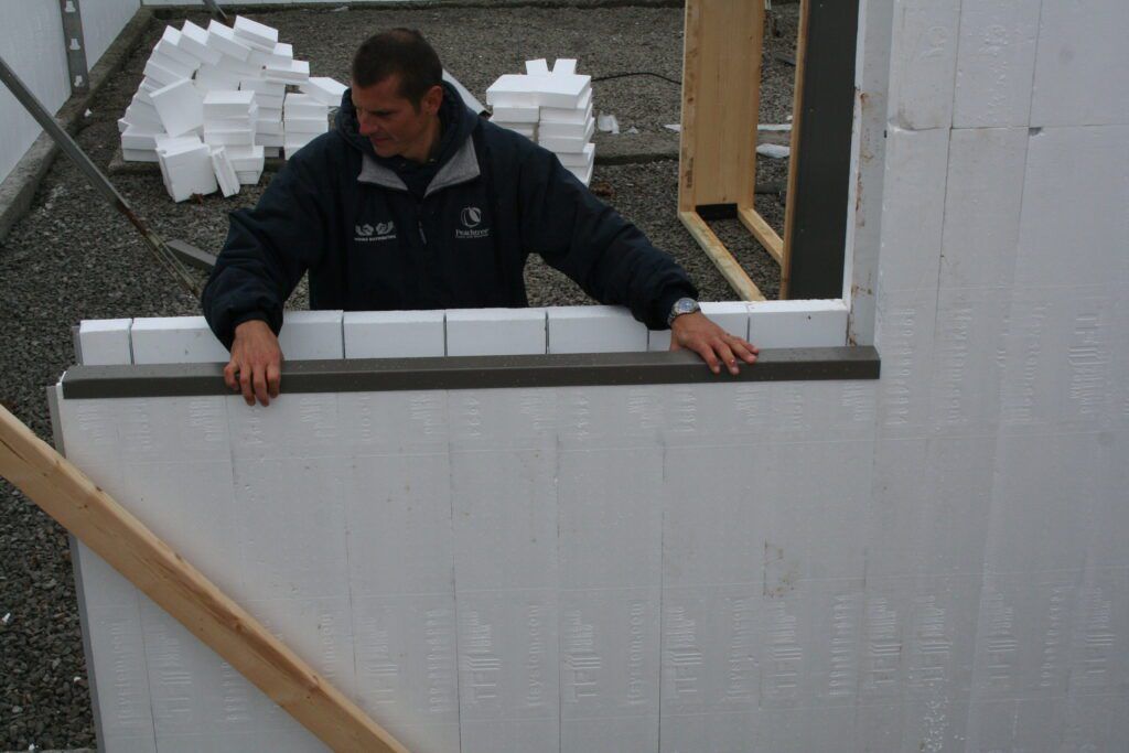 Crew sliding vertical panels into the track